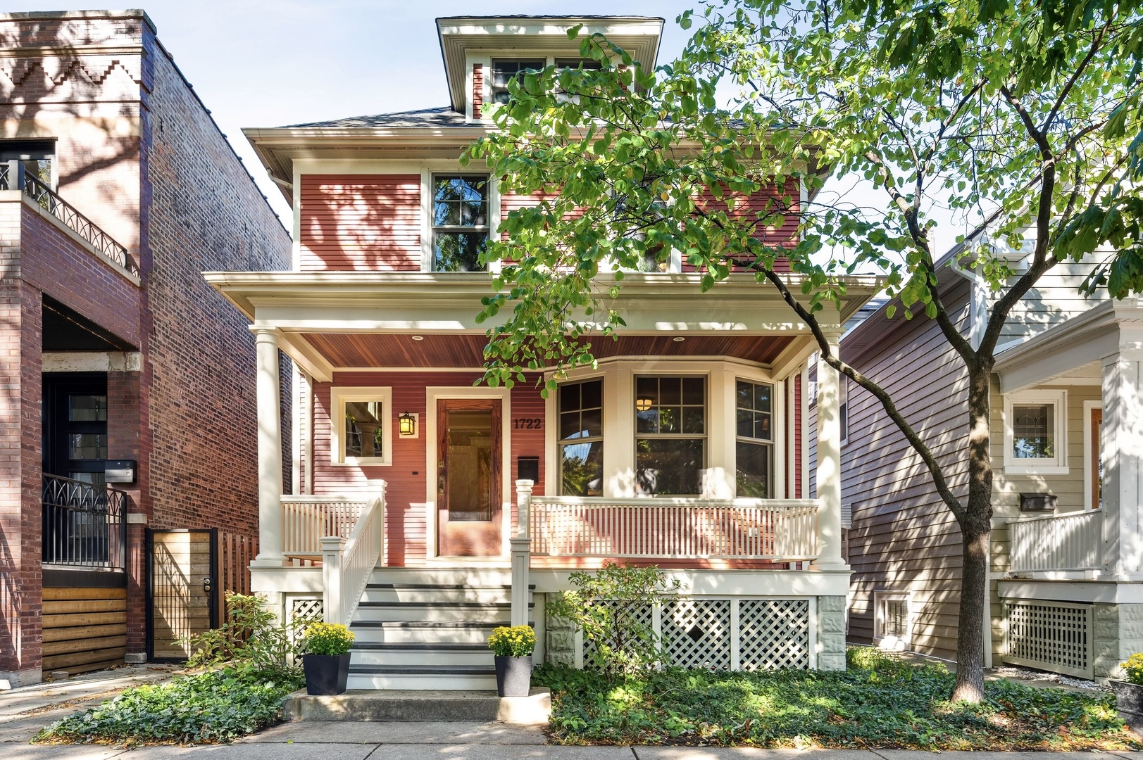 front view of a house with a tree