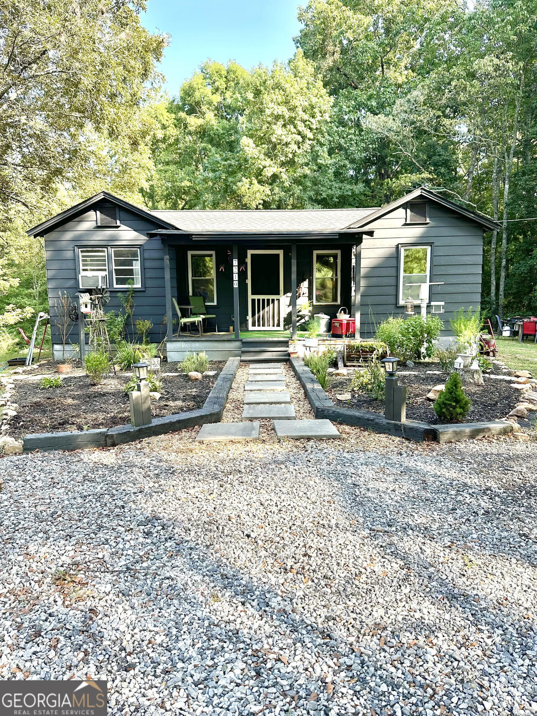 a front view of house with yard and green space