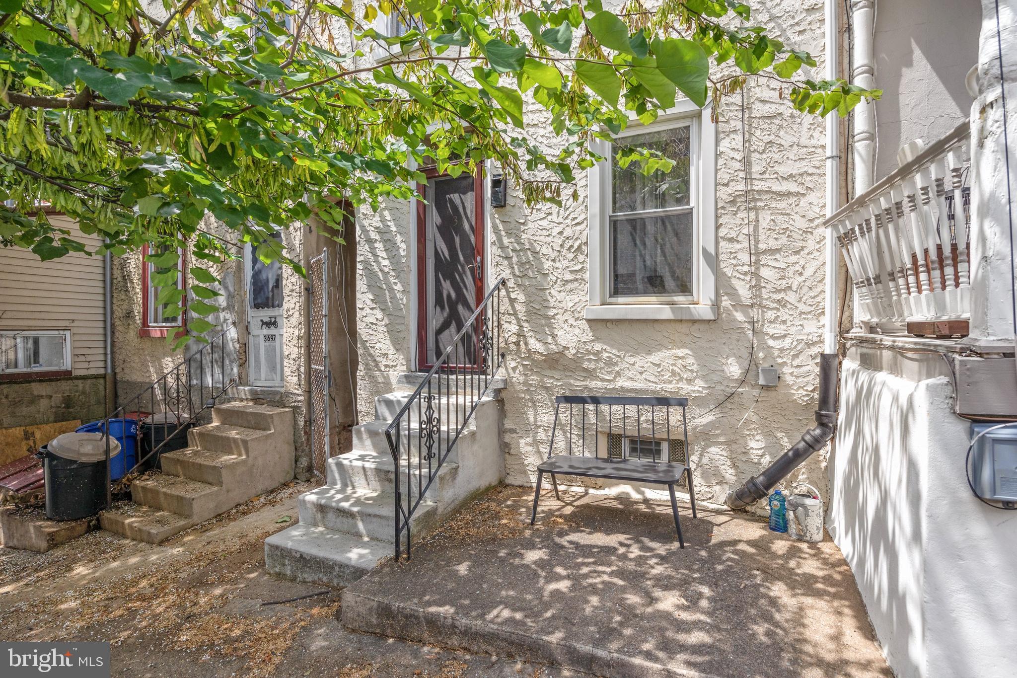 a view of front door of house with outdoor seating