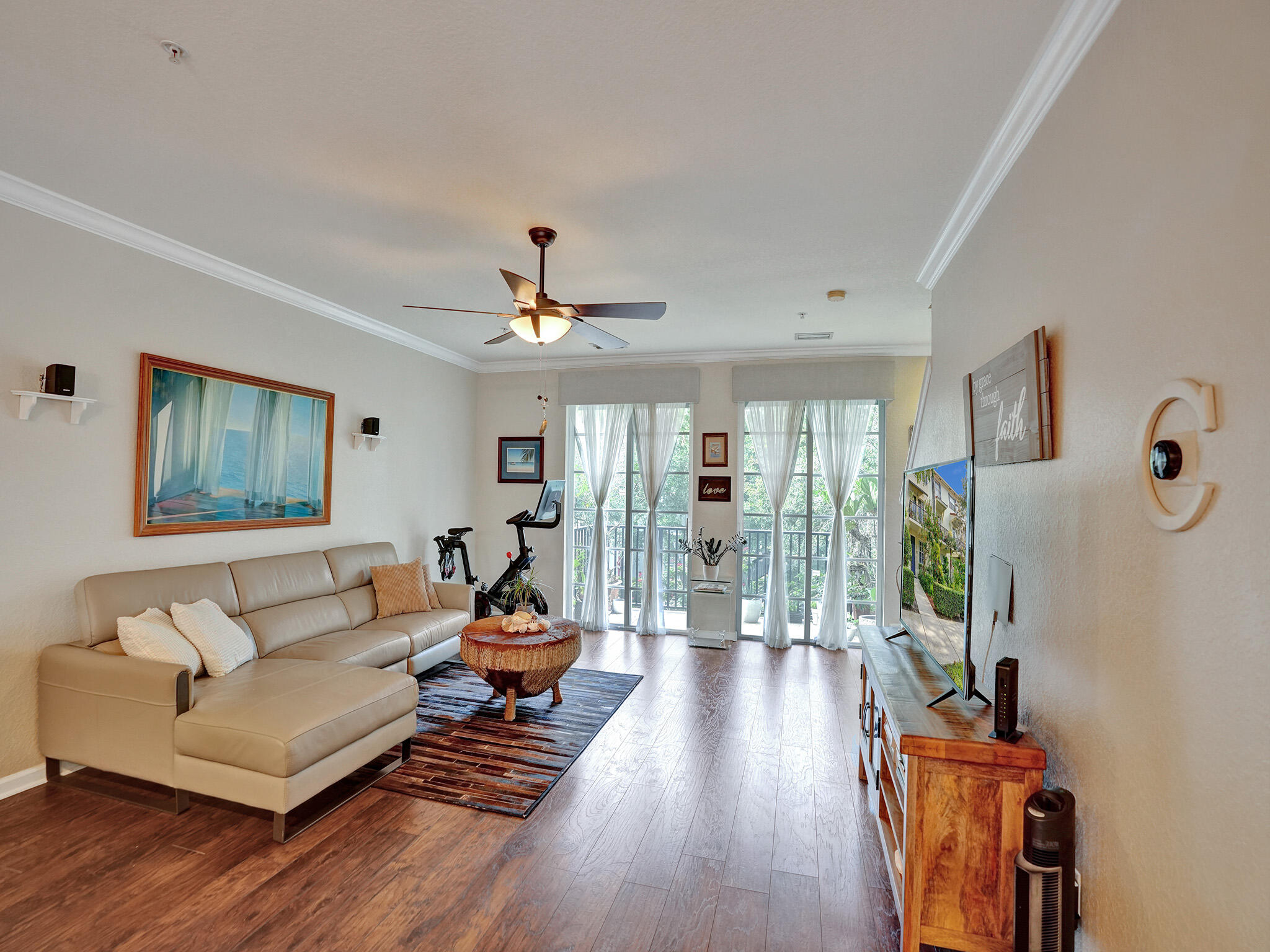 a living room with furniture and a wooden floor