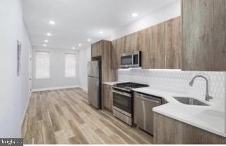 a kitchen with a sink a stove and refrigerator