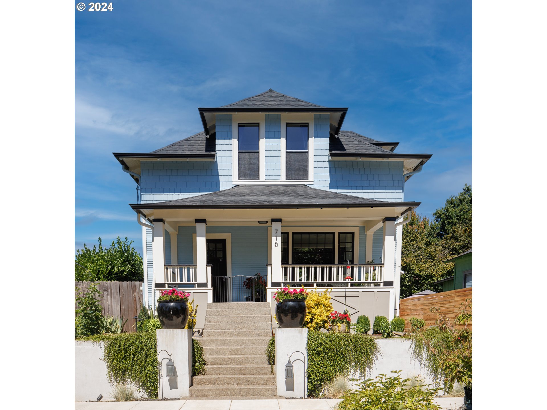 a front view of a house with garden