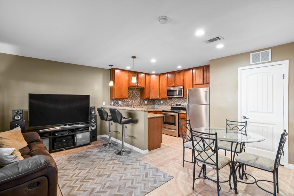 a living room with patio furniture and a flat screen tv