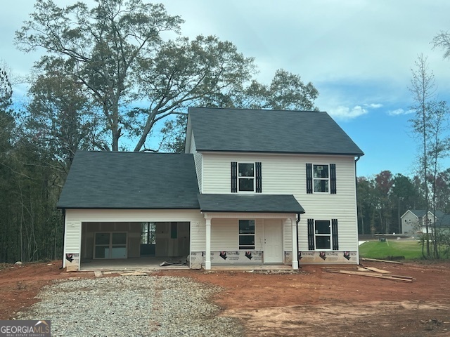 a front view of a house with yard and trees