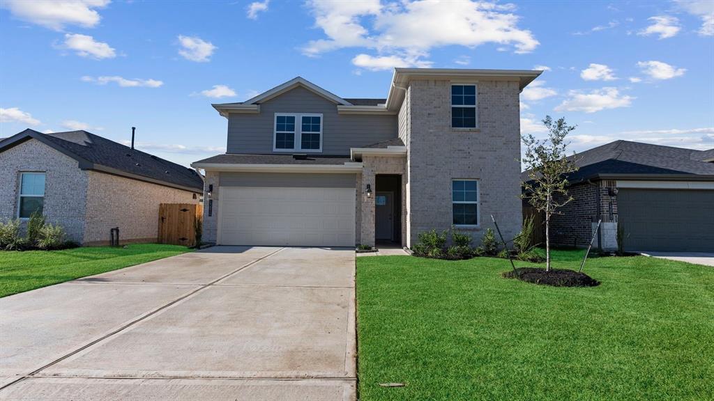 a front view of a house with a yard and garage