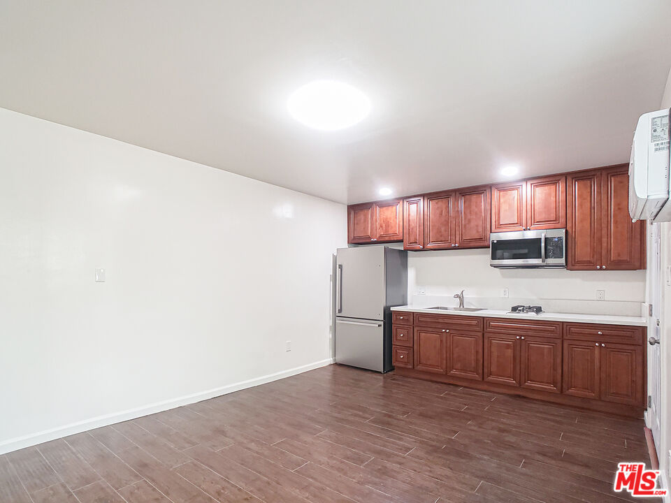 a kitchen with stainless steel appliances wooden cabinets and a sink