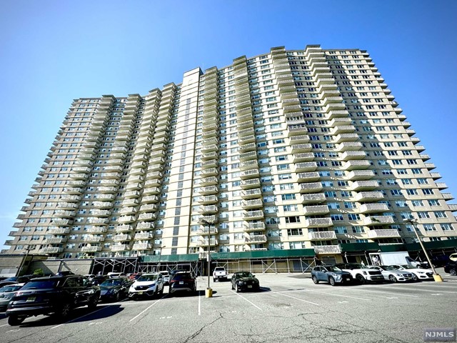 a front view of a building with parking space