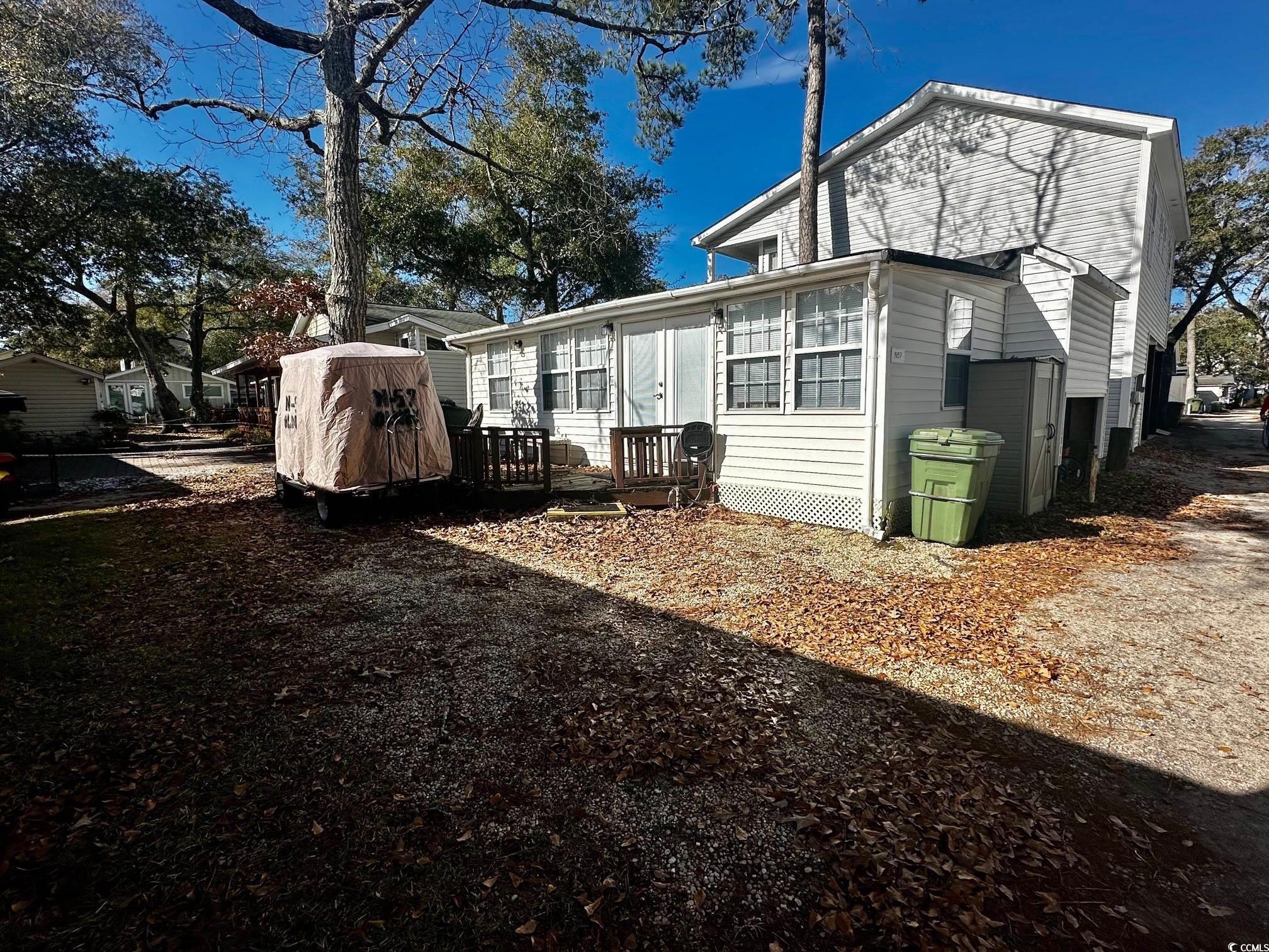 Back of house with a deck