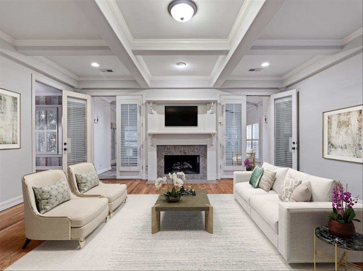 a living room with furniture a fireplace and a flat screen tv