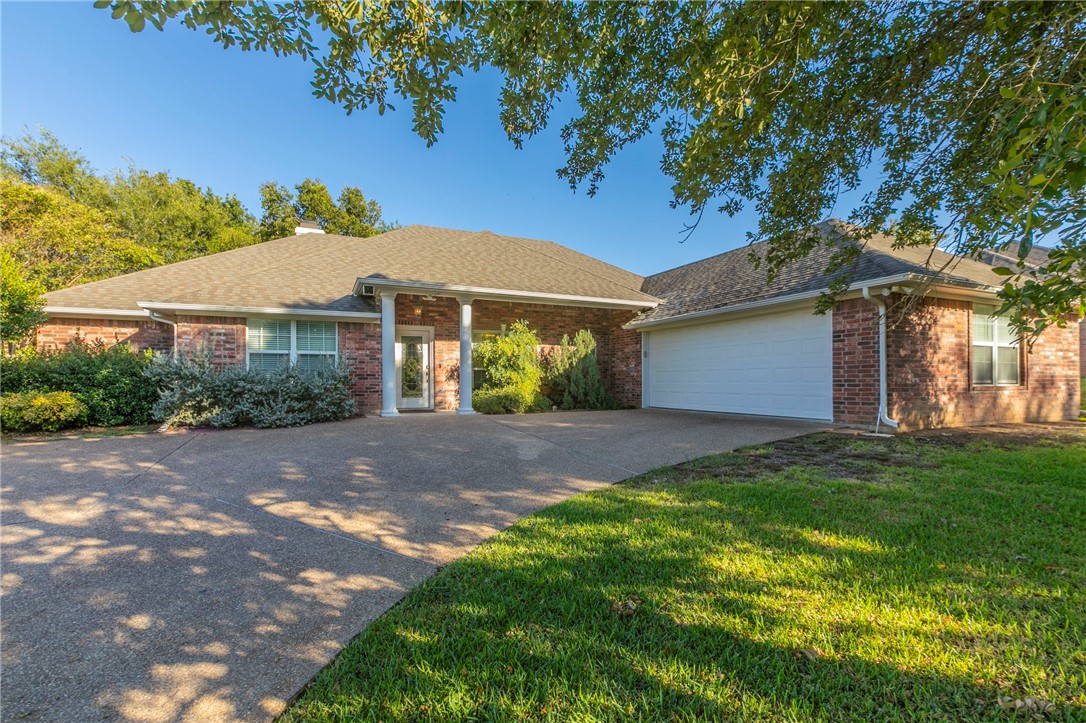 a view of a house with a yard and tree s