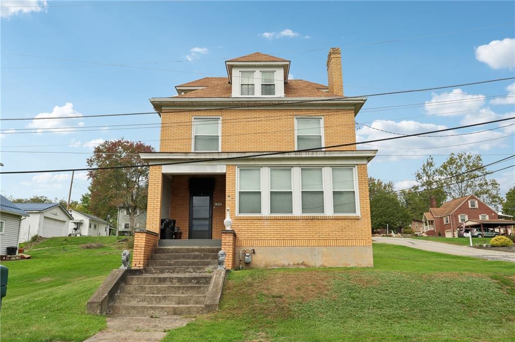 a front view of a house with a yard