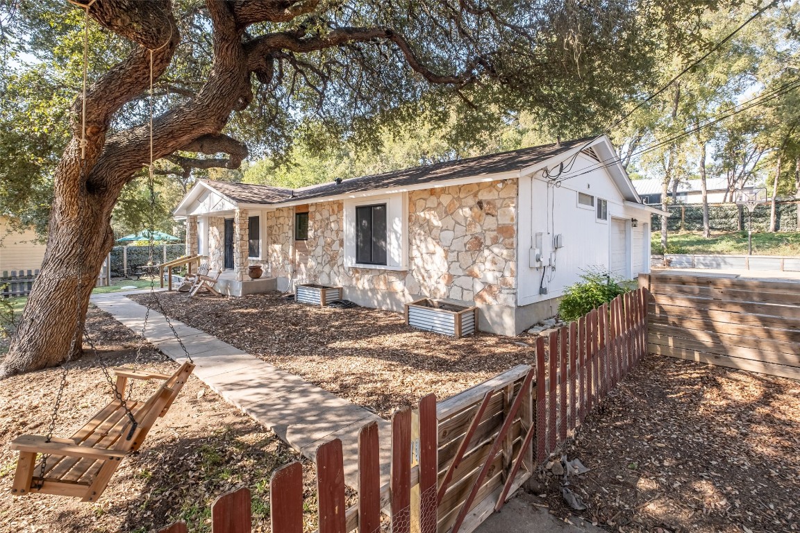 a view of a house with backyard and sitting area