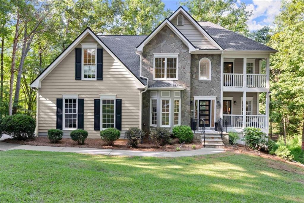 a front view of a house with a yard and garage