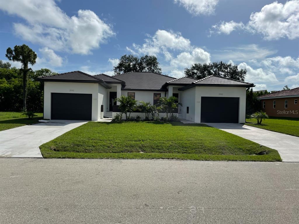 a front view of a house with a yard and garage