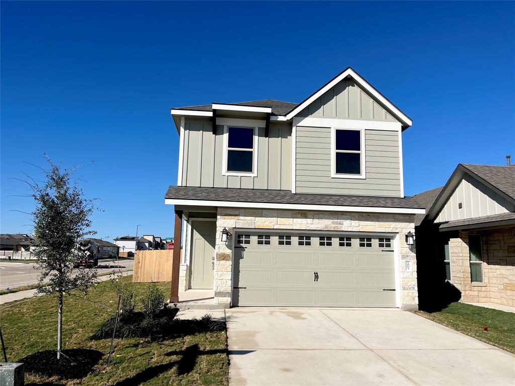 a front view of a house with a garage