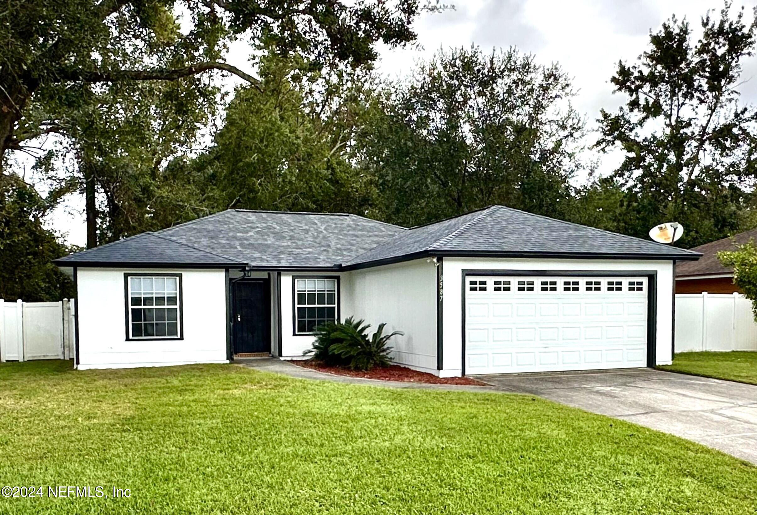 a front view of a house with a yard and garage