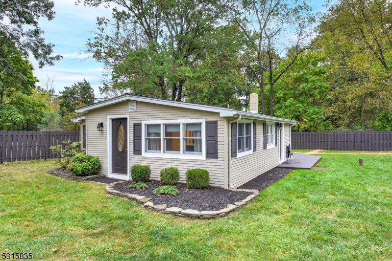 a view of a house with a yard and sitting area