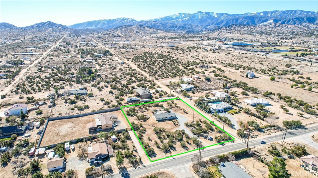 an aerial view of residential house and sandy dunes