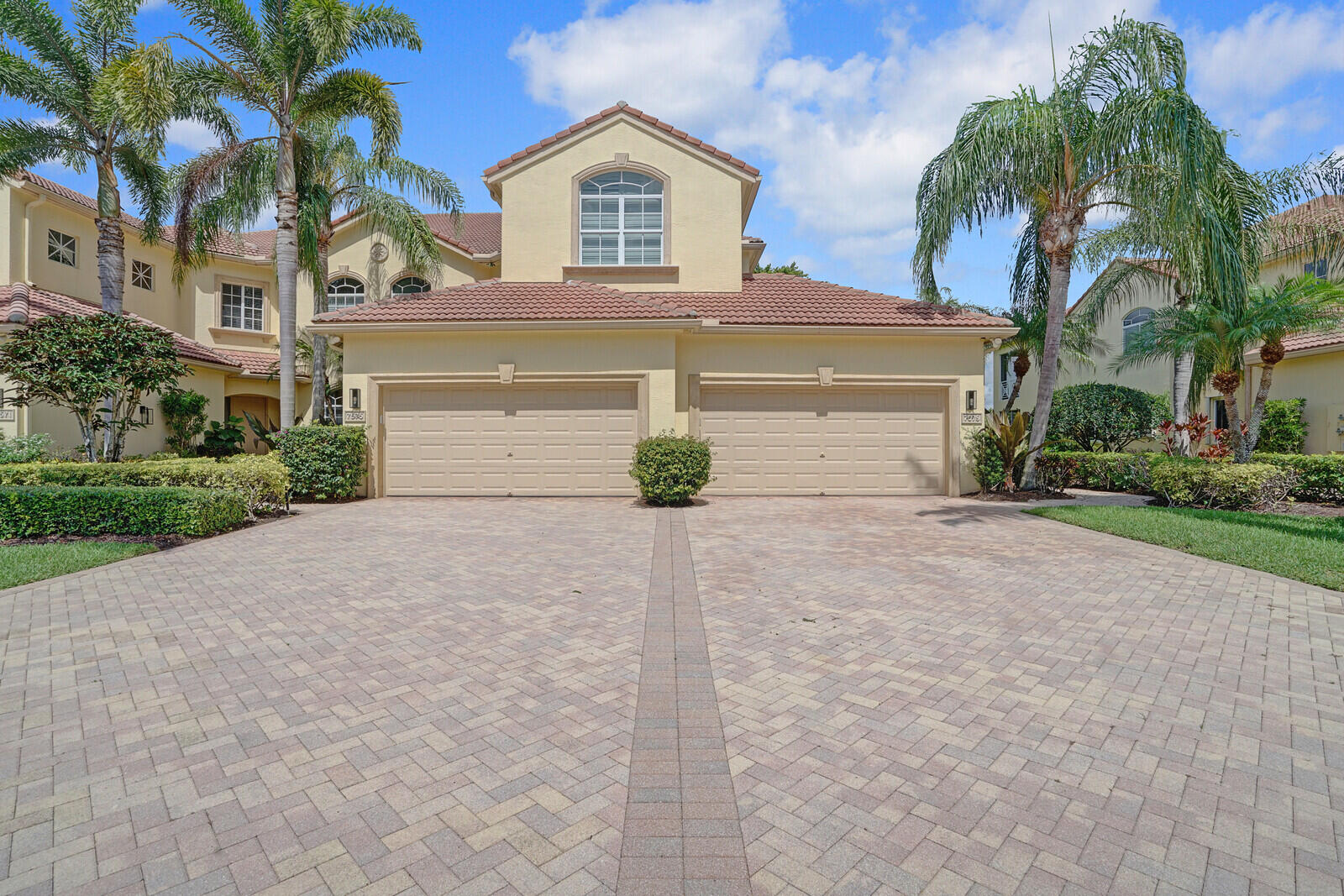 a view of the house with a yard and garage