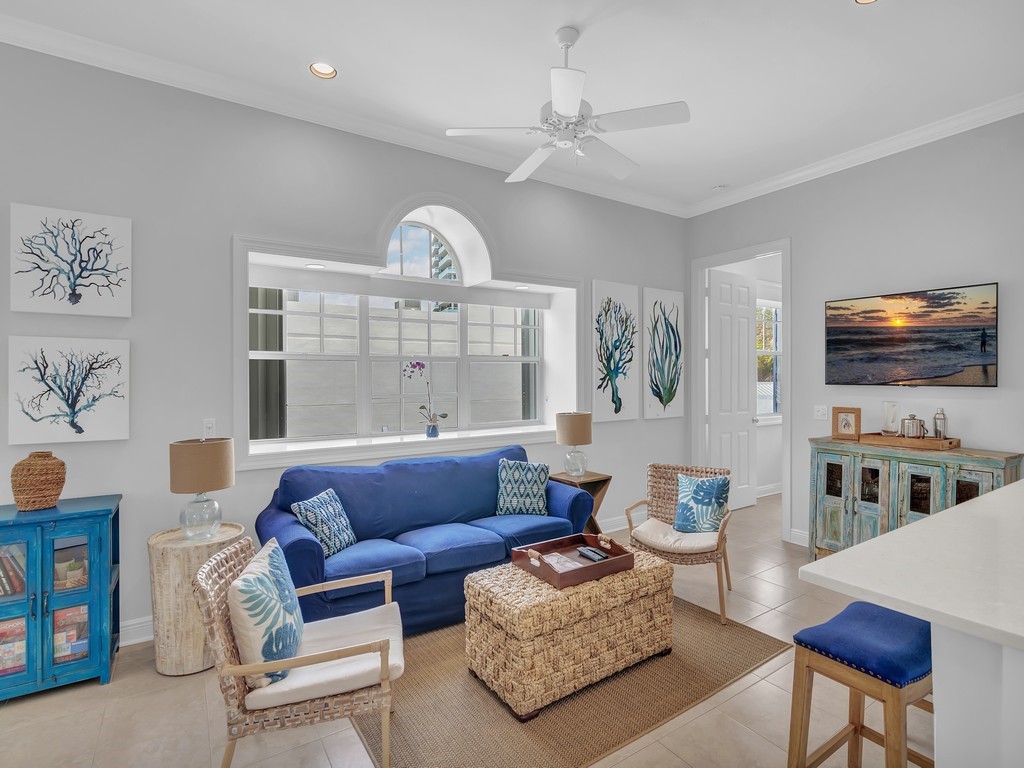 a living room with furniture a rug and a flat screen tv