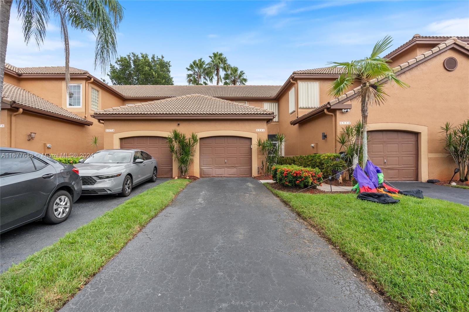 a view of a house with a yard and garage