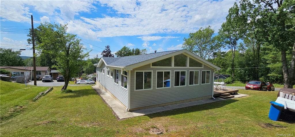 a view of a house with a yard deck and a slide