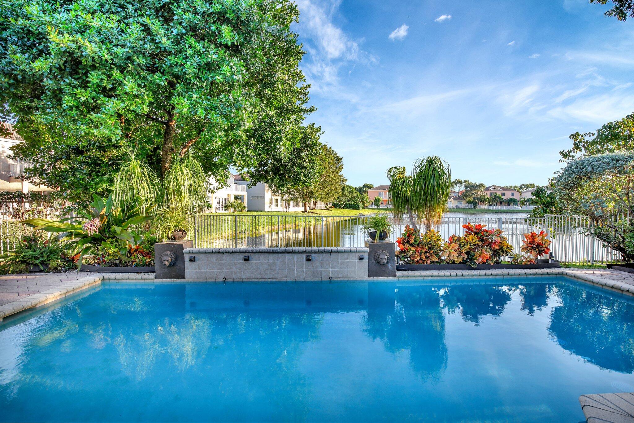 a view of a swimming pool with an outdoor seating and a yard