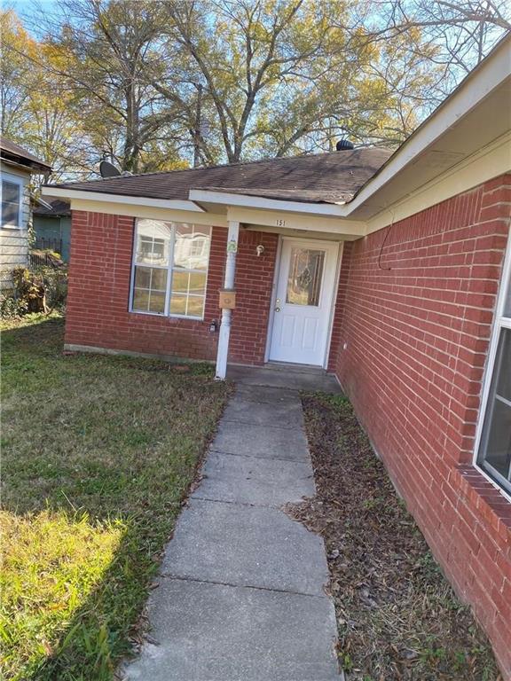 a view of front door of house with yard