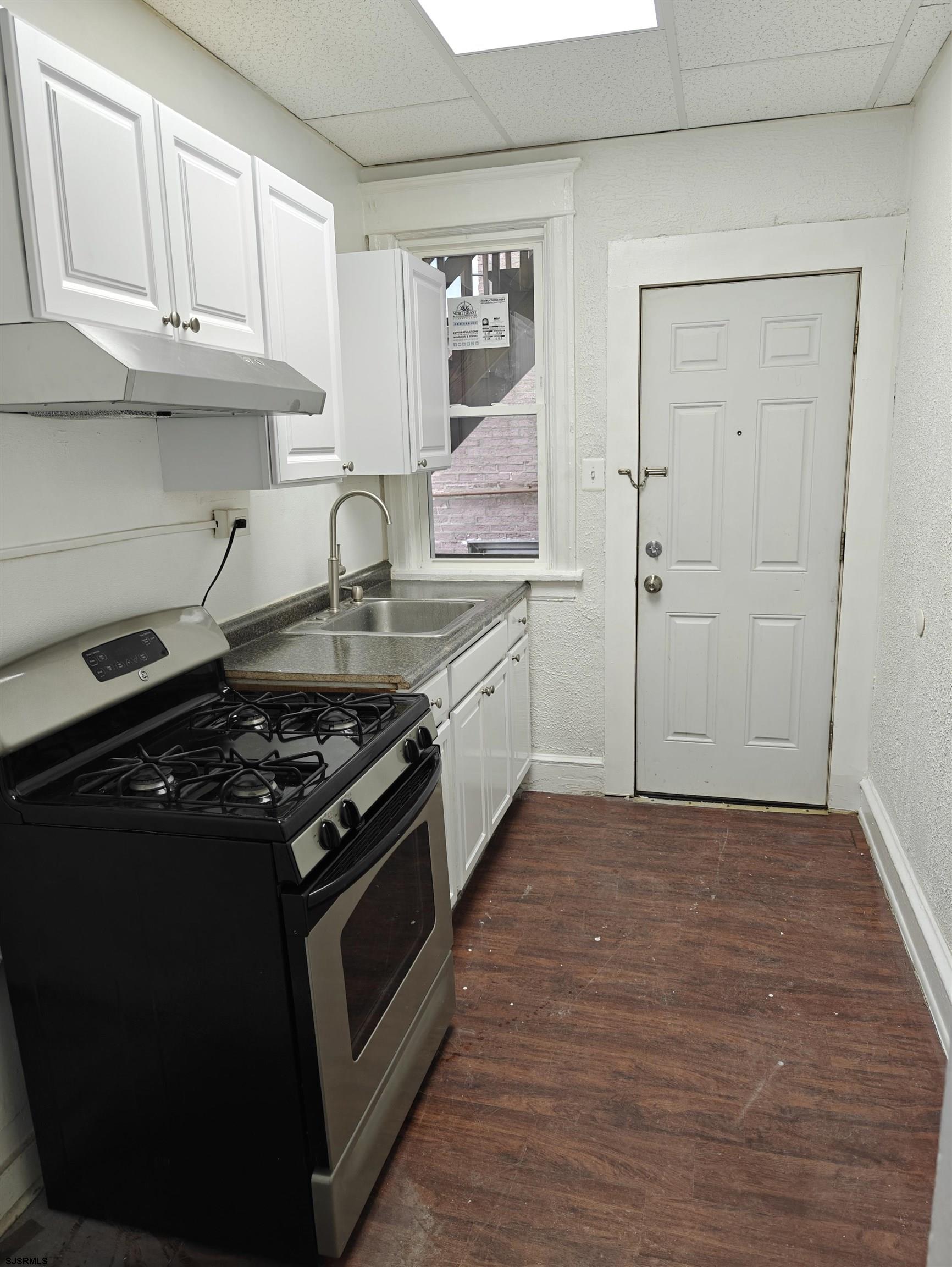 a kitchen with stainless steel appliances granite countertop a stove and a refrigerator