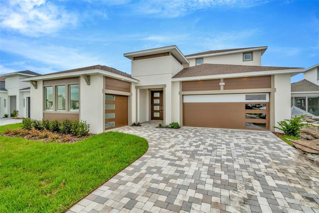 a front view of a house with a yard and garage