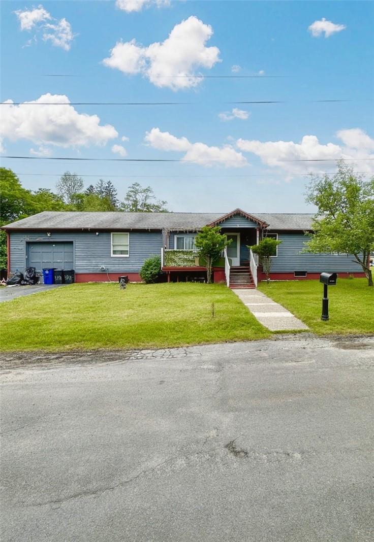 Single story home with a front yard