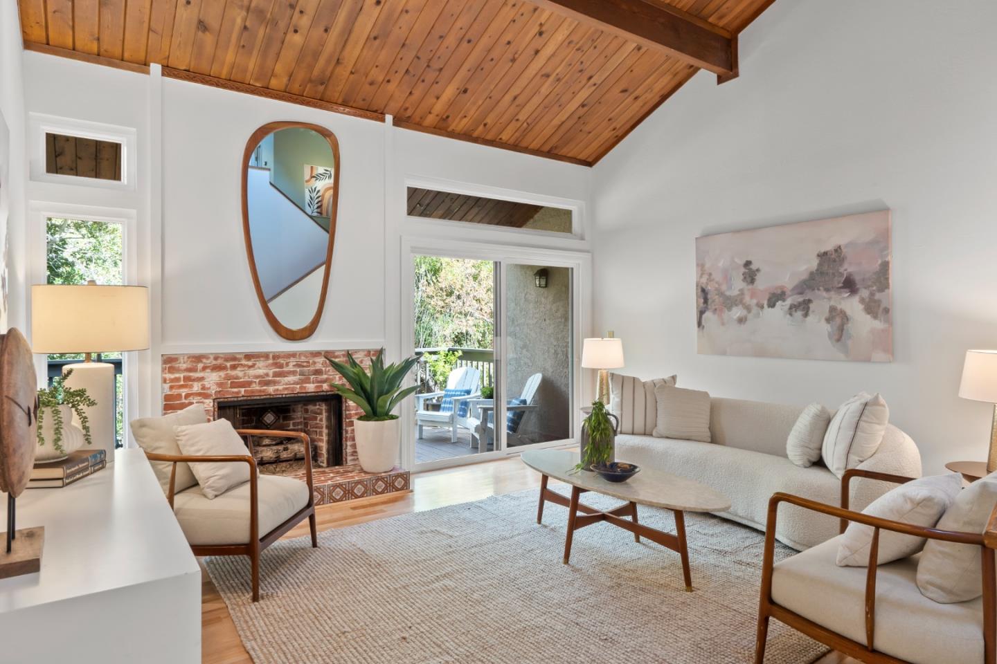 a living room with furniture a rug and a large window