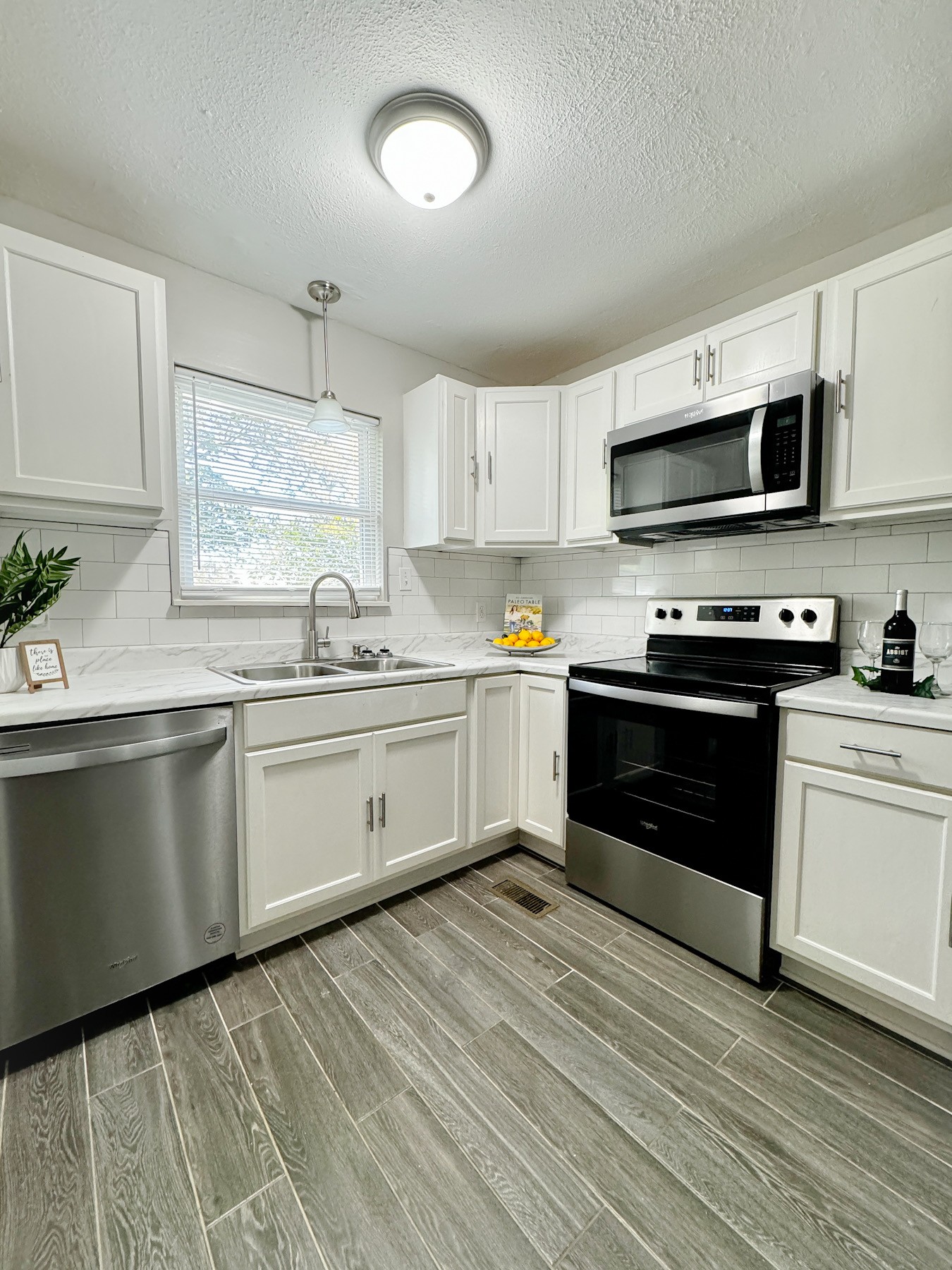 a kitchen with stainless steel appliances granite countertop a stove sink and cabinets