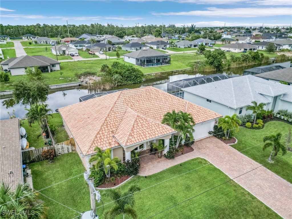 an aerial view of a house with a garden and trees