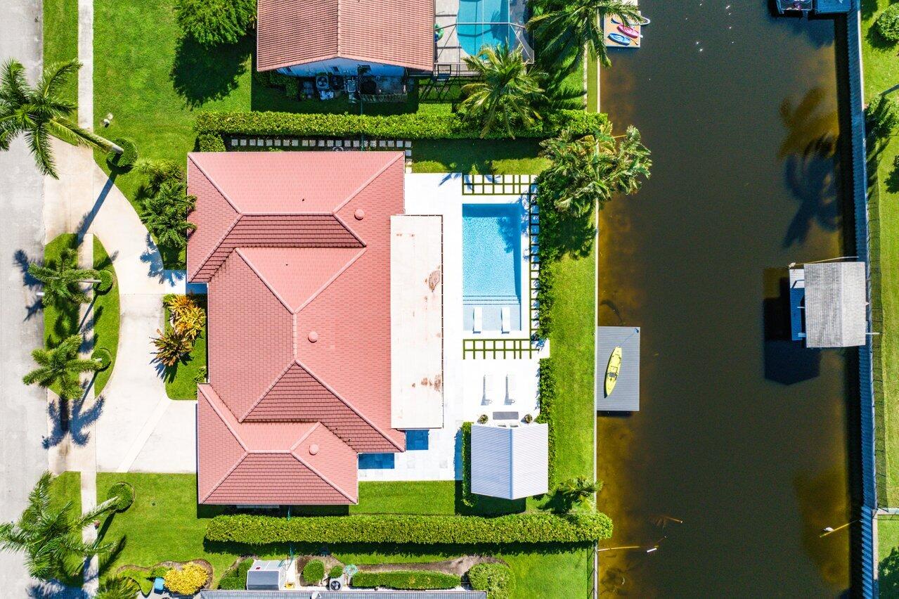 an aerial view of a house with swimming pool and garden