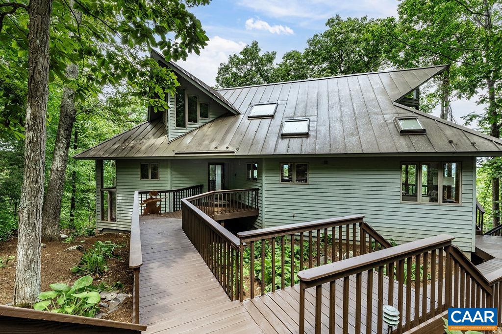 a view of house with backyard and outdoor seating