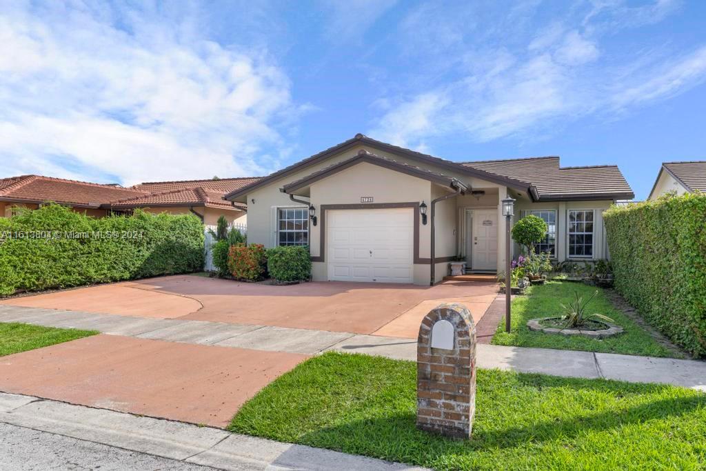 a front view of a house with a yard and garage