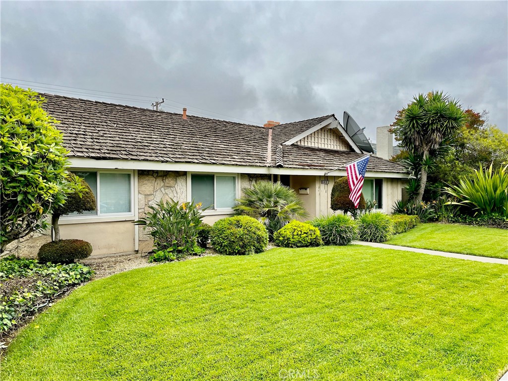 a front view of a house with garden and porch