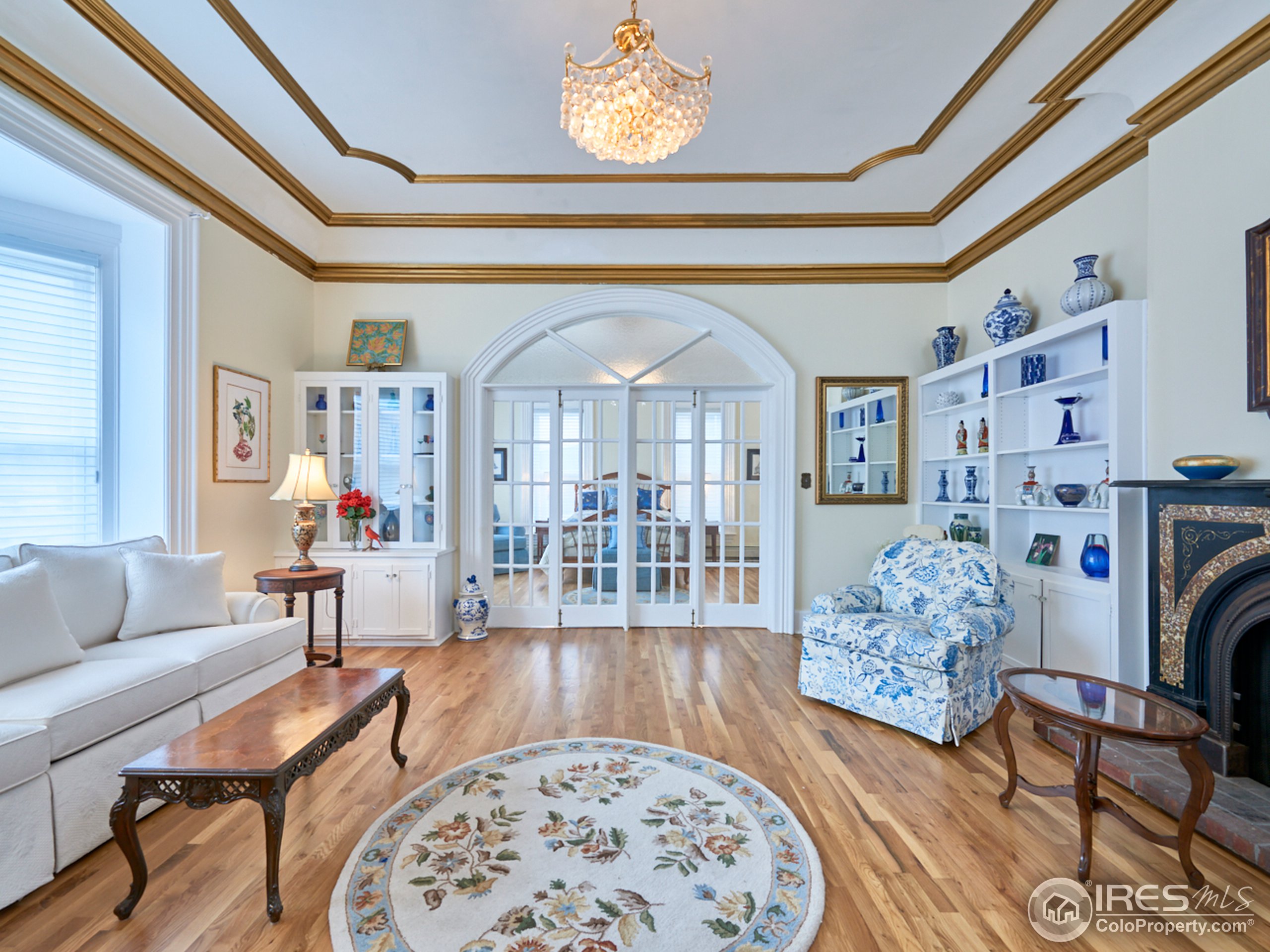 a living room with furniture and a chandelier