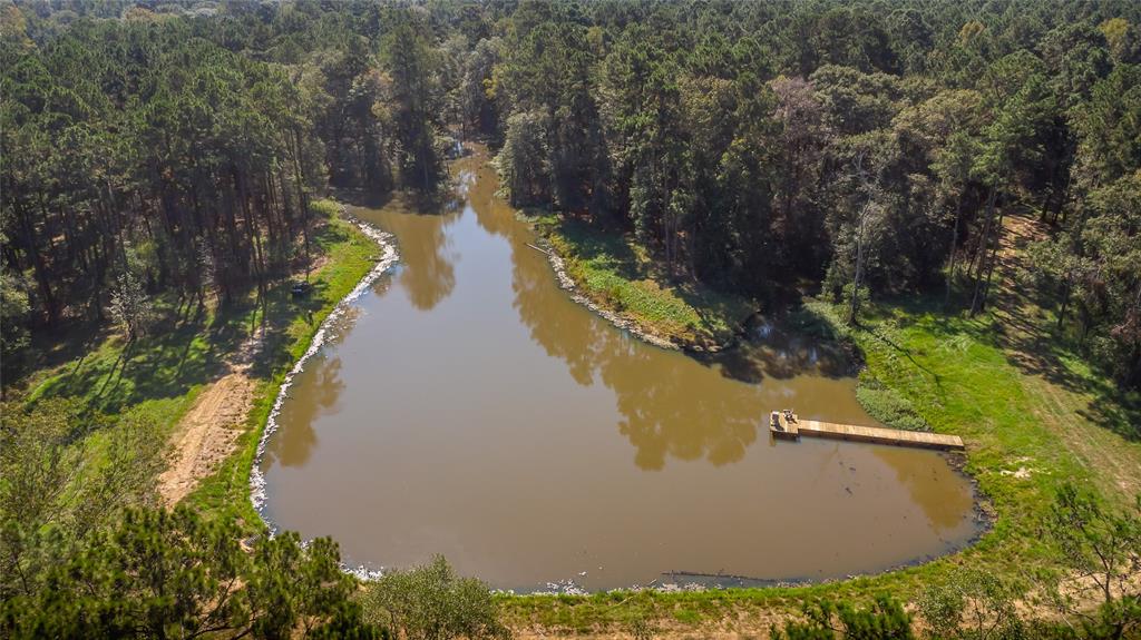 an aerial view of a house with a yard and lake view