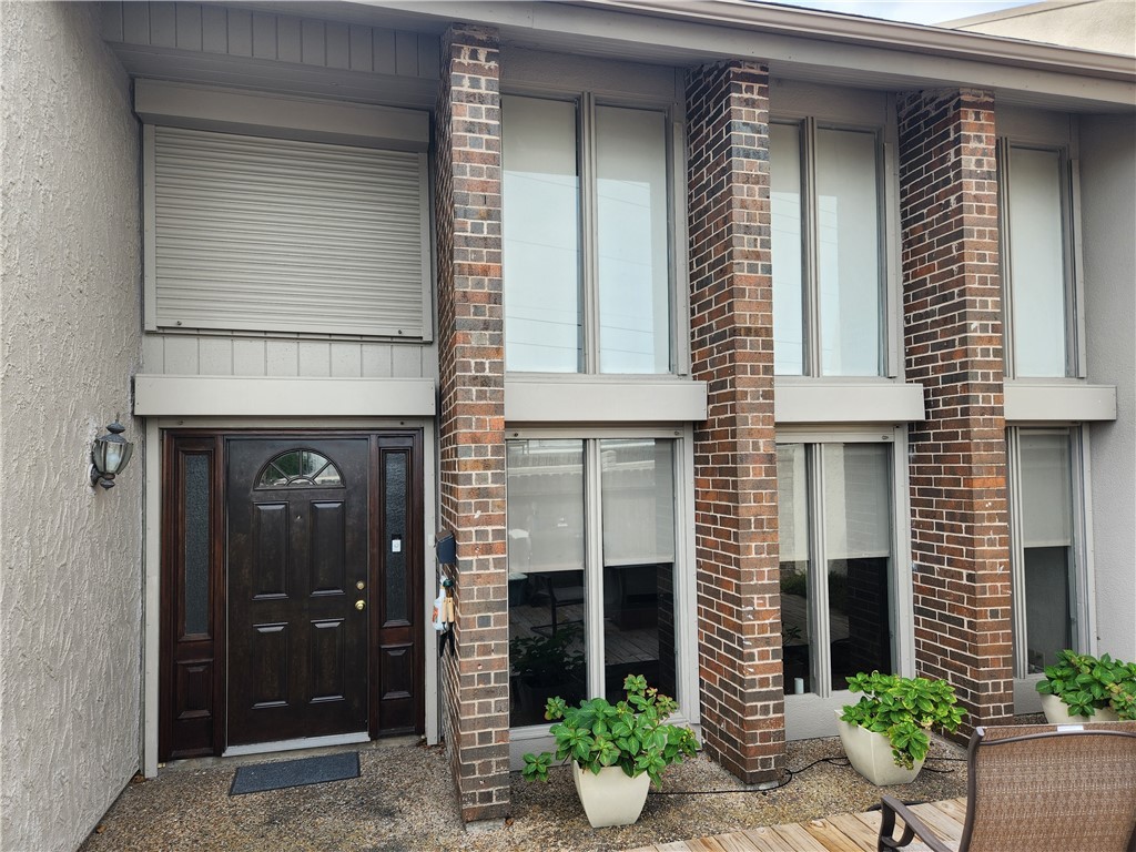 a front view of a house with potted plants