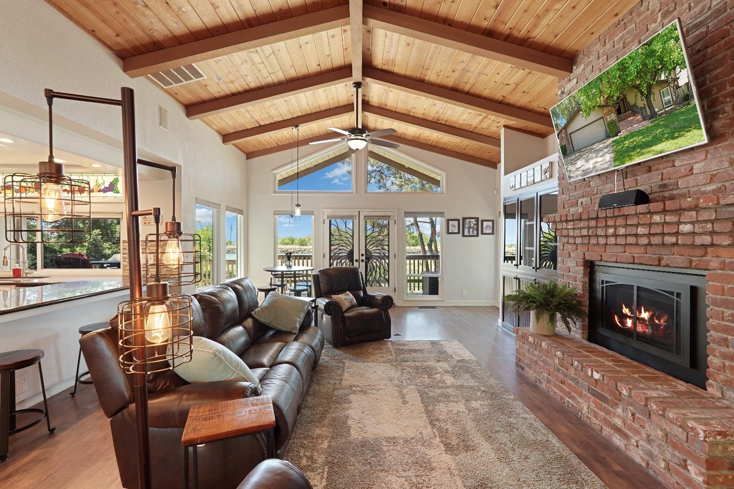 a living room with furniture a fireplace and a ceiling fan