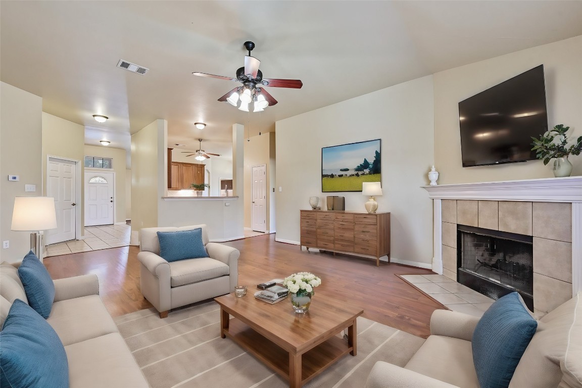 a living room with furniture a flat screen tv and a fireplace