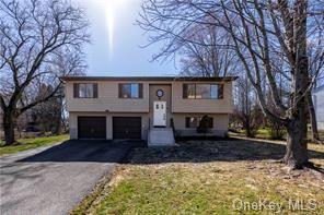 Split foyer home featuring a garage