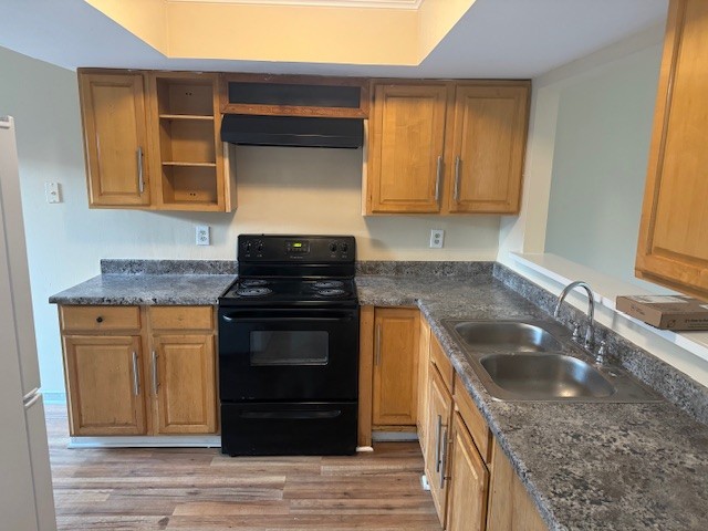 a kitchen with granite countertop stainless steel appliances wooden cabinets and a sink