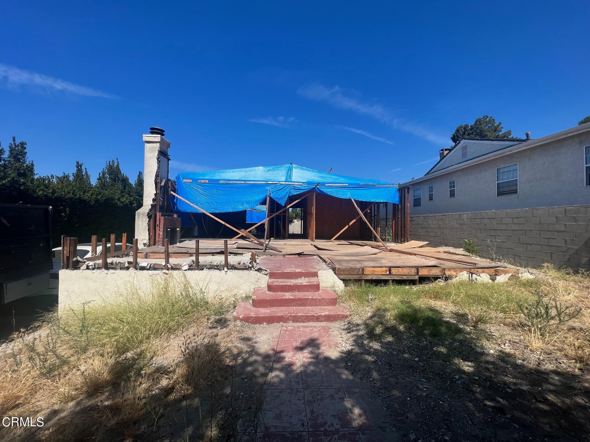 a view of a house with swimming pool and sitting area