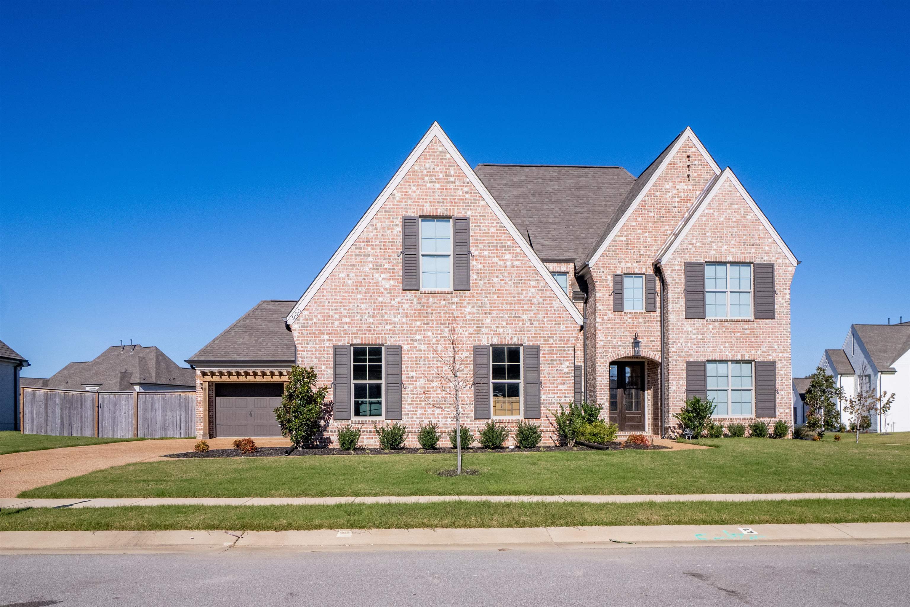 View of front of house featuring a front yard and a garage