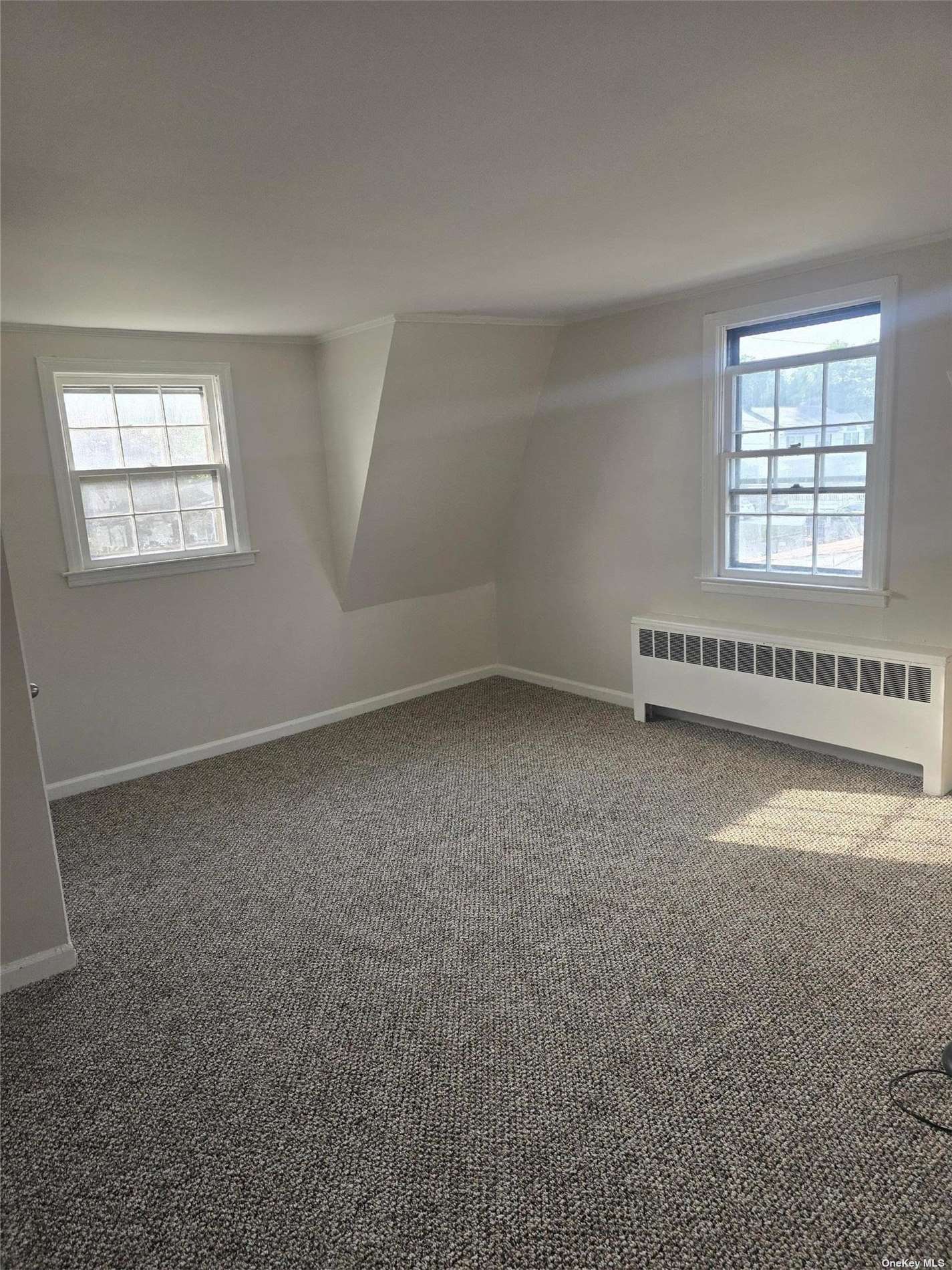 an empty room with a empty space and windows