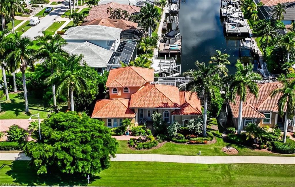 an aerial view of a house with garden space and lake view