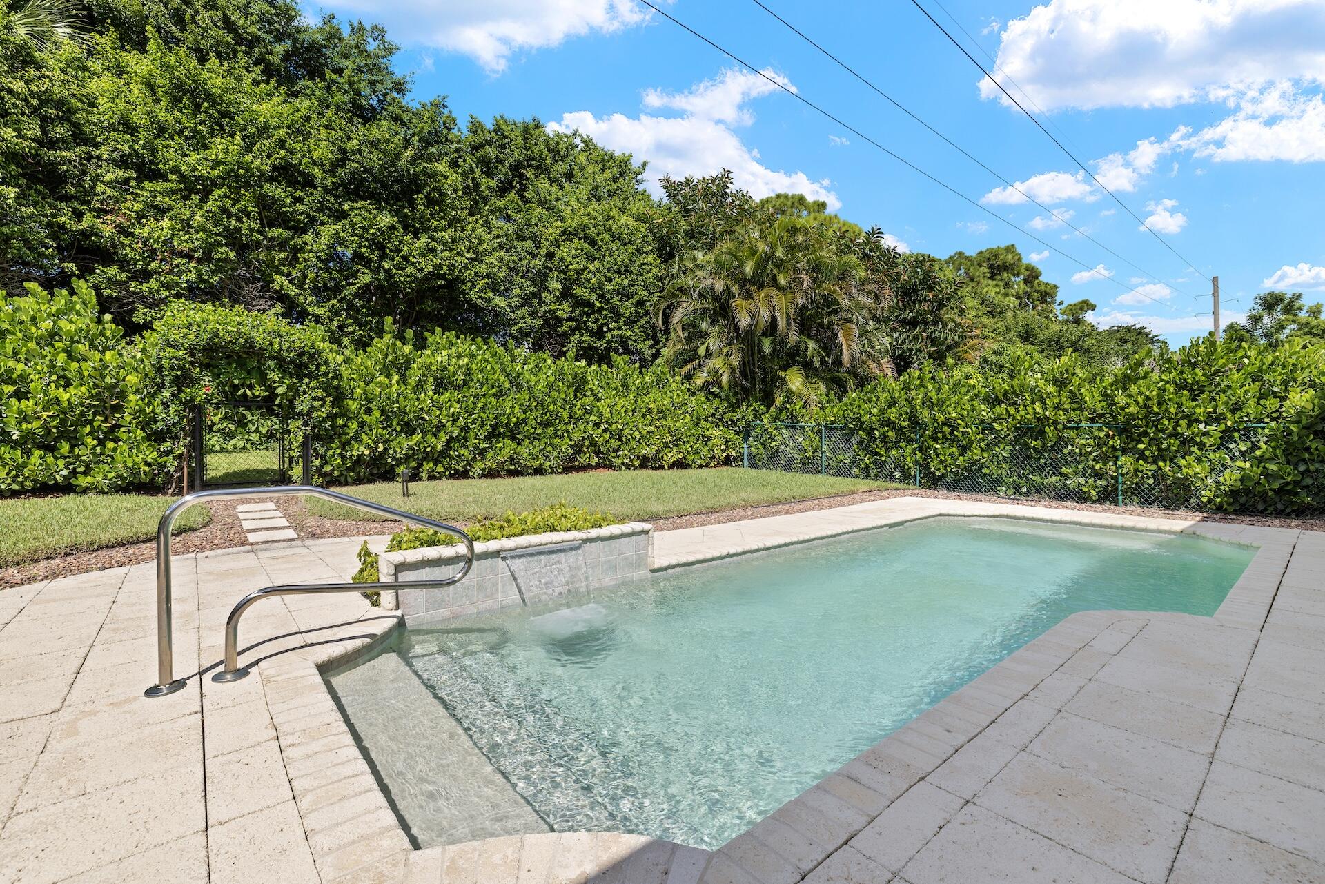 a view of a swimming pool with a yard